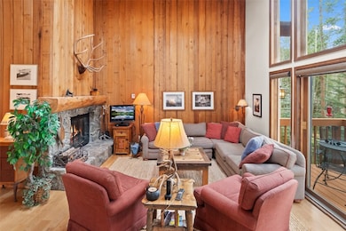 Living room featuring a towering ceiling, a firepl