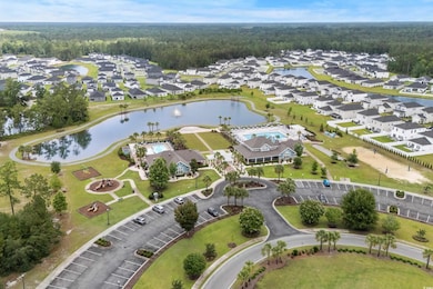 Aerial perspective of suburban area with a forest and a nearby body of water