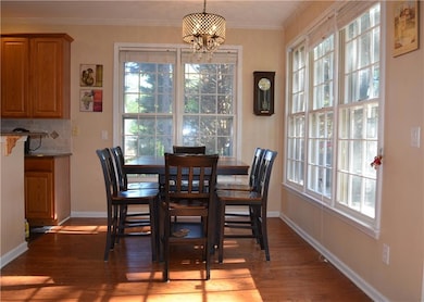 Dining room with wood finished floors, a wealth of