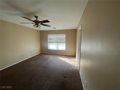 Carpeted empty room featuring visible vents, baseb