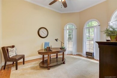The office/living features three gorgeous arched w