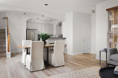 Dining space with stairway, light wood-type floor
