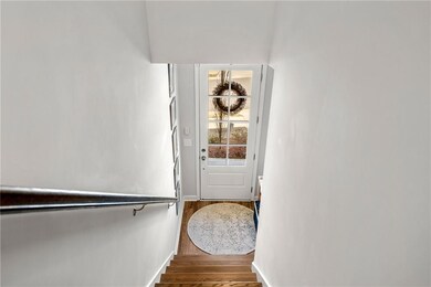 Stairs with baseboards and wood finished floors