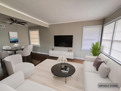 Living room featuring baseboards, wood finished fl