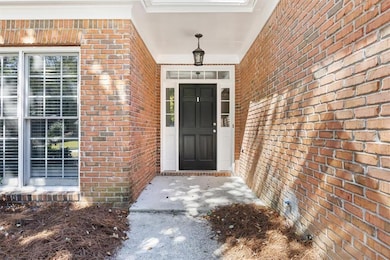 View of exterior entry featuring brick siding