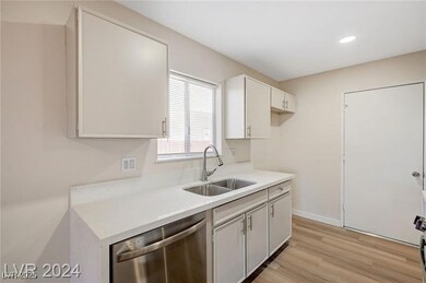 Kitchen featuring stainless steel dishwasher, ligh