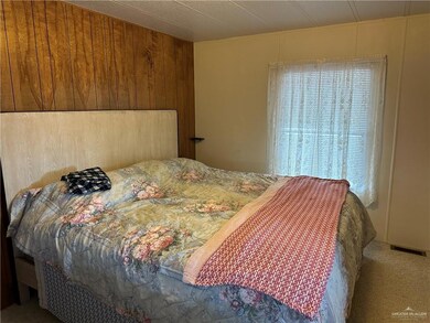 Carpeted bedroom with wooden walls
