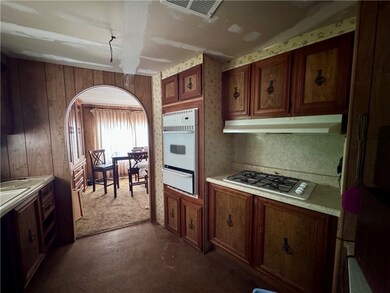 Kitchen with oven, light countertops, stainless st