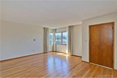 Living room features newly refinished hardwood flo