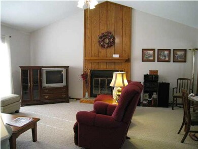 Nice size living room with a vaulted ceiling and c