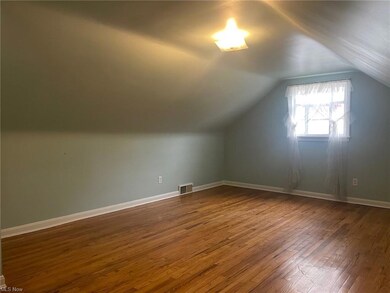 upstairs bedroom featuring hardwood flooring, a cl