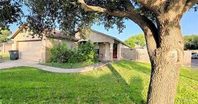 View of front of home featuring brick siding, concrete driveway, and a garage