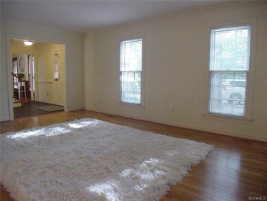 Living room has wide cased openings to foyer and d