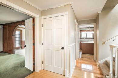 Foyer features Hardwood Floors and crown molding