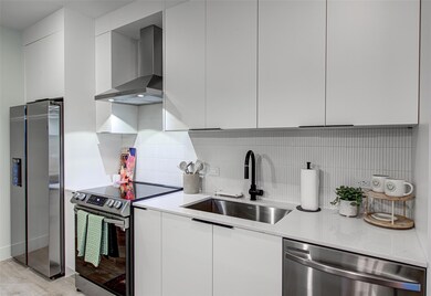 Kitchen featuring stainless steel appliances, wal