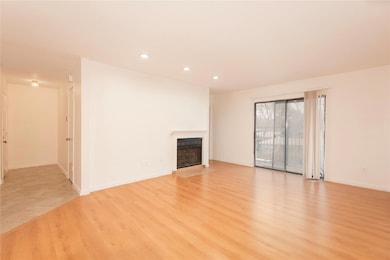 Living room featuring baseboards, light wood-type 