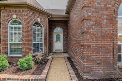 Entrance to property featuring brick siding