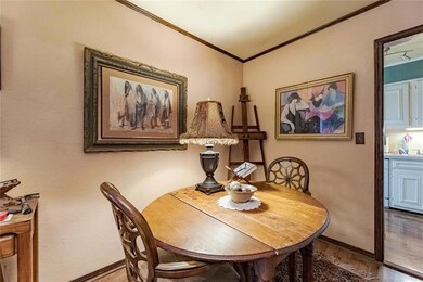 Dining room featuring ornamental molding and wood-
