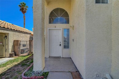 Property entrance with stucco siding and a gate