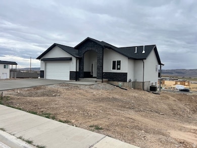 View of front of house featuring stone siding, stucco siding, concrete driveway, a porch, and a garage