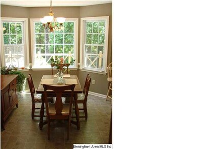 Eat-in kitchen with bay window is adjacent to larg
