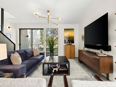 Living area featuring a chandelier and baseboards