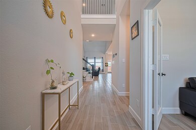 Welcoming entryway with high ceilings, wood-look t