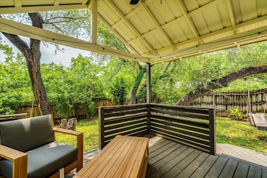 Wooden terrace with a fenced backyard and view of