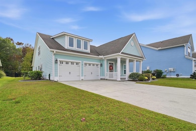 View of front facade with a front yard, a porch, a garage, concrete driveway, and a shingled roof
