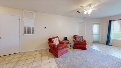Living area featuring light tile patterned floors