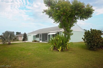 Rear view of property featuring a yard