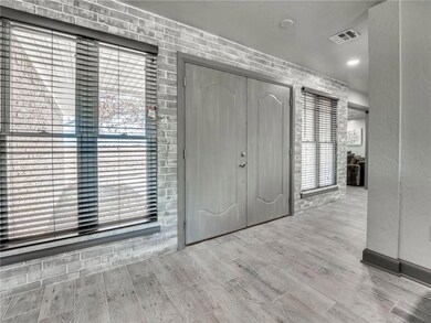 Front entry/living area features brick accent wall