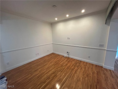 Unfurnished room featuring wood finished floors, o