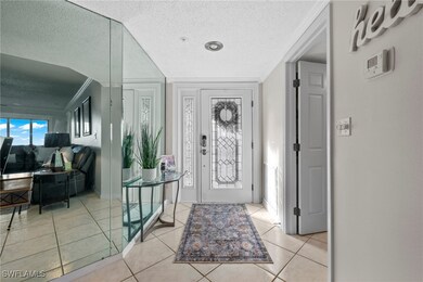 Tiled entrance foyer with custom mirrors.  Laundry