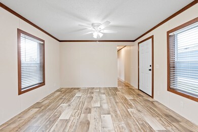 Bright living room showcasing the Aztec Natural wall panels and Caramel trim and window casings
