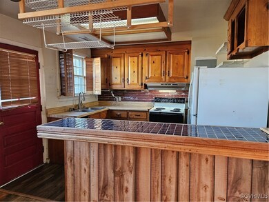 Kitchen featuring fridge, range, ventilation hood,