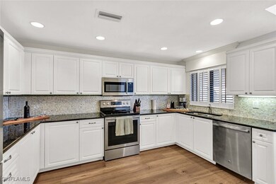 Kitchen with light wood-type flooring, a sink, vis