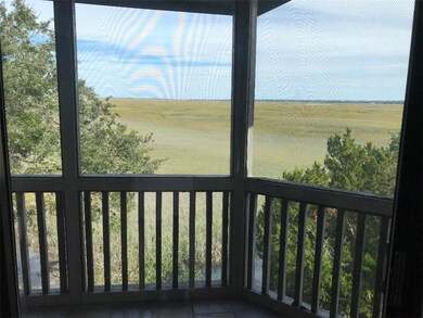 covered screened in 
balcony overlooks marsh