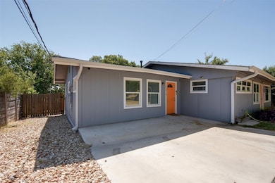 Single story home with a patio and fence