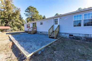 Back of property featuring crawl space and entry steps