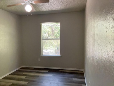 Empty room featuring a textured wall, a textured 