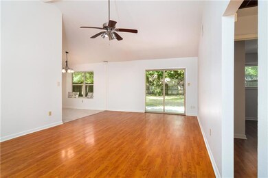 Living room features cathedral ceiling
