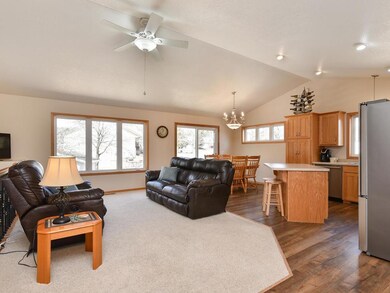 Open view of living, dining and kitchen with patio