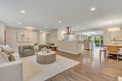 Living area featuring a skylight, recessed lighting, and light wood-style floors
