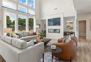 Living area featuring wood finished floors and a high ceiling