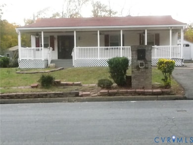 View of front of property featuring a porch and a front lawn