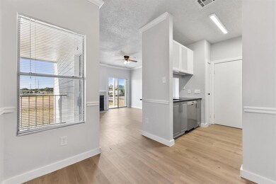 Kitchen featuring a textured ceiling, visible ven