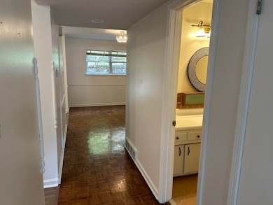 Hallway featuring dark parquet floors