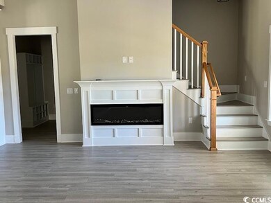 Unfurnished living room featuring wood-type floori