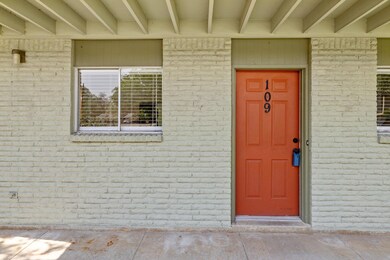 View of exterior entry featuring brick siding